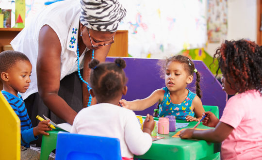 Teacher with children in Pre-K classroom