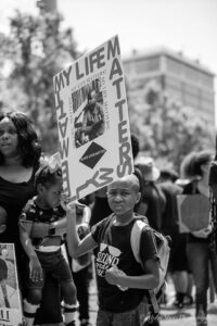 Young Black Protester carrying a My Life Matters poster