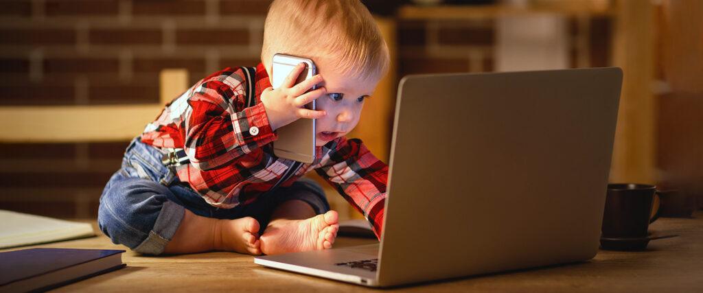 Image showing a toddler virtually working from home. 