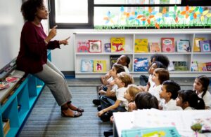 Early Childhood Educator teaching school class of children and toddlers.
